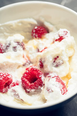 Healthy and tasty breakfast with curd, sour cream, raspberry and honey. Selective focus.
