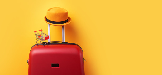 concept of shopping abroad, hat at suitcase with shopping cart over trend yellow background, panoramic mock up image