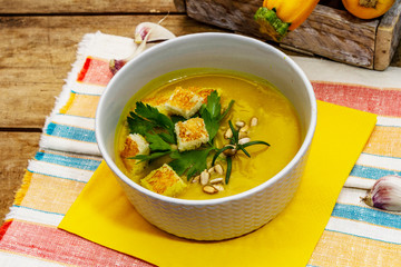 Yellow zucchini cream soup. Healthy vegan (vegetarian) food, crispy toast, sunflower seeds, whole ripe fruits, fresh greens