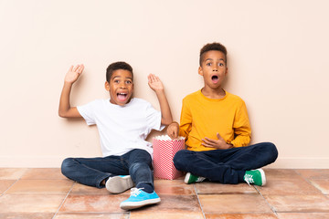 African American brothers  holding popcorns and doing surprise gesture