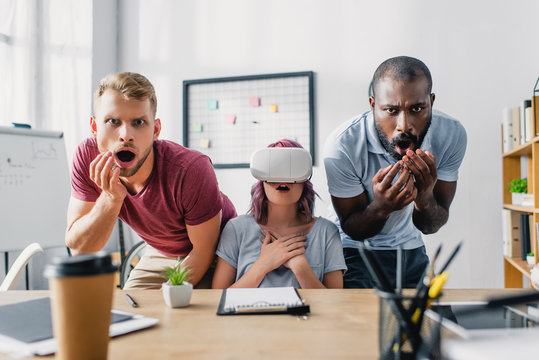 Selective focus of multiethnic business people with vr headset in office - Powered by Adobe