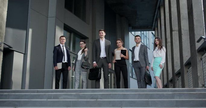 Happy proud professional diverse business people group look at camera. Corporate team portrait. Smiling team of diverse different generations business people looking at camera