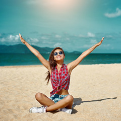 Beautiful girl enjoying freedom on a beach