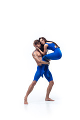 Fototapeta na wymiar Touch. Couple of modern dancers, art contemp dance, blue and white combination of emotions. Flexibility and grace in motion and action on white studio background. Fashion and beauty, artwork concept.