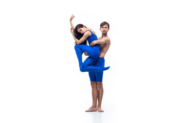 Winter. Couple of modern dancers, art contemp dance, blue and white combination of emotions. Flexibility and grace in motion and action on white studio background. Fashion and beauty, artwork concept.