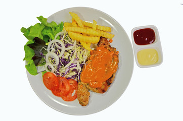 Pork steak in white dish and small seasoning sauce
