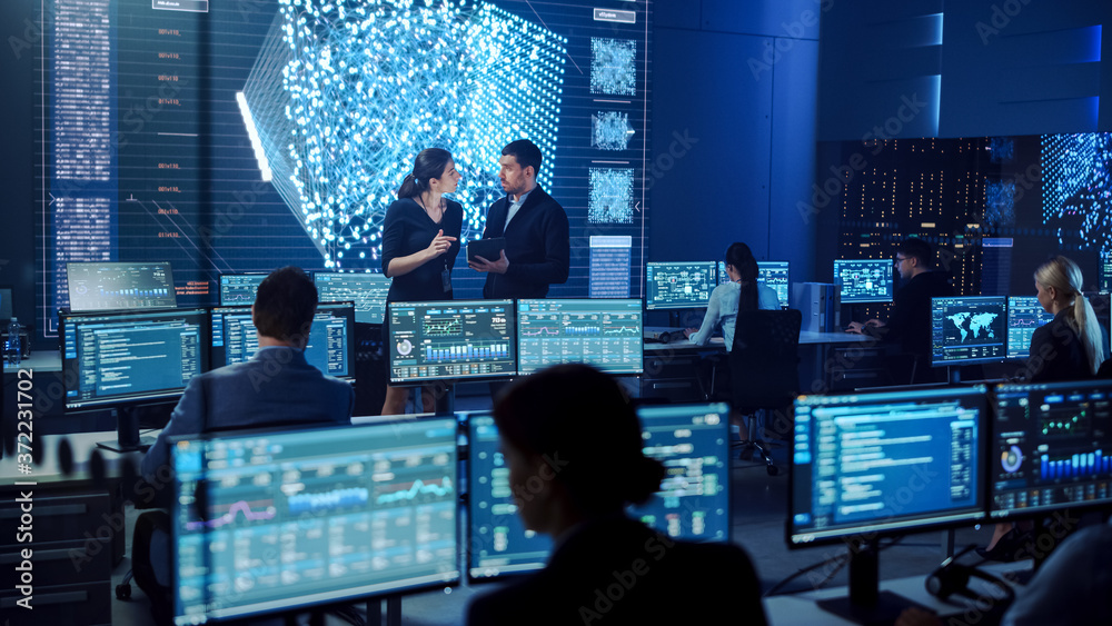 Poster Project Manager and Computer Science Engineer Talking while Using A Digital Tablet Computer. Telecommunications System Control Monitoring Room with Neural Network on Big Screen.