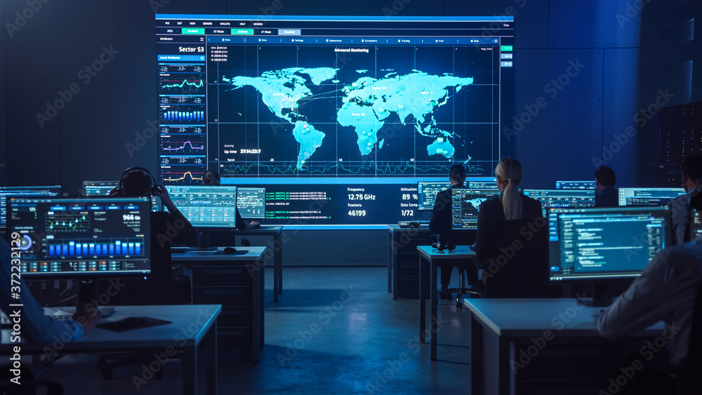 Poster Team of Professional Computer Data Science Engineers Work on Desktops with Screens Showing Charts, Graphs, Infographics, Technical Neural Network Data and Statistics. Dark Control and Monitoring Room.