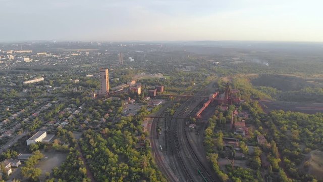 City mine and quarry red iron ore headframe aerial drone right side panorama camera movement Krivoy Rog Ukraine