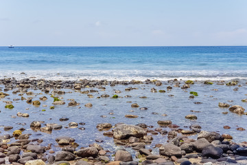 View on Indian ocean coast with pebble and sand beach on Bali, Indonesia