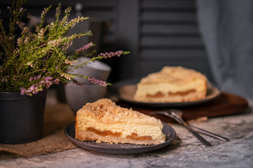 Rustic grated cottage cheese cake with caramel on grey table. Homemade crumb pie. Portion of  organic, healthy, country dessert. Copy space.