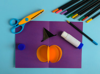 Diy Halloween card with pumpkin on purple background.Gift idea, decor Halloween.Instruction.Step by step.Top view. Children Halloween craft. Workshop.Flat lay. Step 8