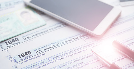Annual tax reporting. Tax form on the table. Financial statements for signature.