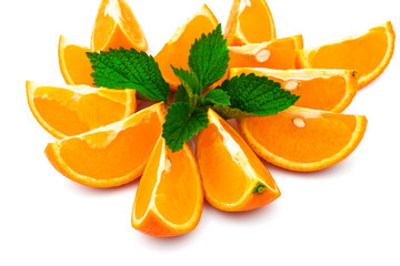 Macro view of orange with slices and green leaf of mint on white background - 372236902