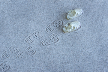 Footprint of a baby sandal at the beach