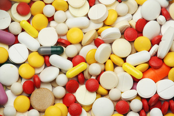 Different colorful tablets at white background