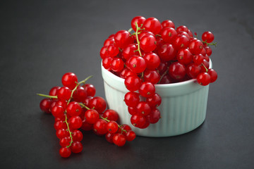A ceramic bowl with red currant berries