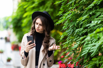 Shocked woman finding surprising news on phone in the street