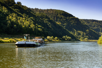 large river barge transporting goods on the Moselle River near Enkirch