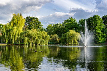 beautiful city gardens and park with a pond and geyser fountain