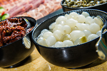 Italian sun dried tomatoes with garlic, bright wooden table background