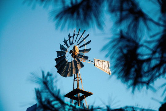 Windmill, with up to aluminum, behind the blue sky.