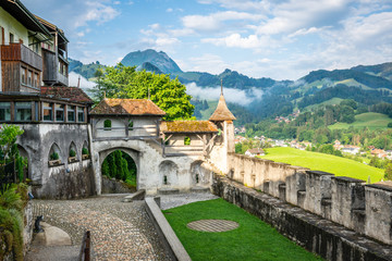 Fototapeta na wymiar Fortification and entrance of the medieval village of Gruyeres in La Gruyere Switzerland