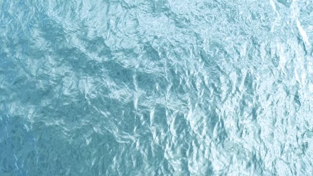 Aerial View of a Crystal clear sea water texture. View from above Natural blue background. Turquoise ripple water reflection in tropical beach. Blue ocean wave. Summer sea. Top view. Waves in motion	
