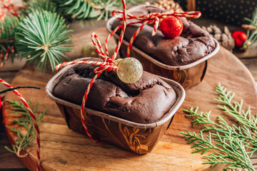 Closeup of chocolate fudge brownies on a plate with Christmas decorations in background