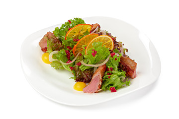 Salad with grilled beef slices and lettuce isolated on white
