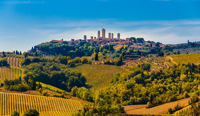 Gorgeous panoramic view of the famous medieval hill town San Gimignano with its stunning towers. It is surrounded by the agricultural countryside, typical for the Tuscan landscape in Italy.
