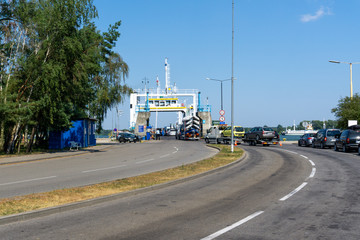 cars drive onto the ferry connecting Swinoujscie and Wolin Island in Poland