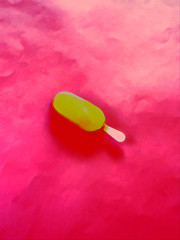 White chocolate ice cream on stick on pink background