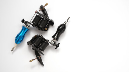 Two tattoo machines on a white background - tattoo industry -space for text