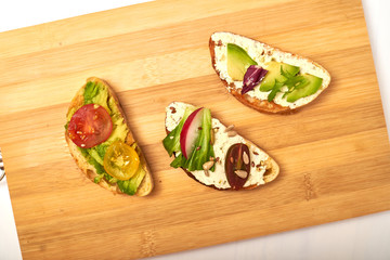 Ciabatta with cream cheese, avocado, various vegetables. Vegetarian sandwiches.