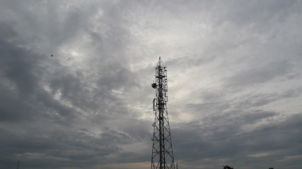 cell phone tower with stormy clouds background 