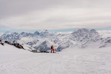 Fototapeta na wymiar a snowboarder standing on a ski slope with a mountain view