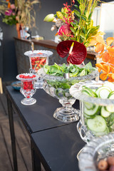 Colorful Gin garnish in glass dishes.