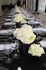 White rose boutiques on a gala dinner table.