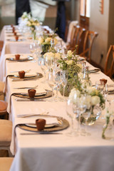 white flowers set up on tables for an event.