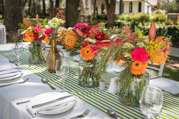 Colorful flowers setup on a table outside.