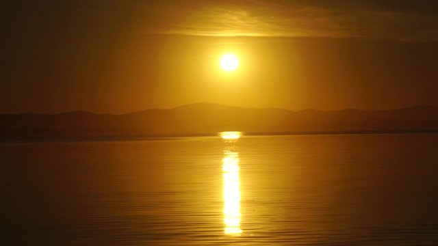 sunset on a mountain lake of the southern ural Uvildy. reflection in water