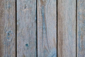 The boards are blue background. View from the front. The old wall. Textural structure.