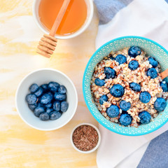 Buckwheat porridge in a bowl with flax seeds and blueberries. oncept healthy food, detox, diet, breakfast, top view