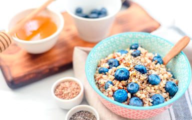 Fototapeta na wymiar High protein healthy breakfast, buckwheat porridge with blueberries, flax seeds and honey