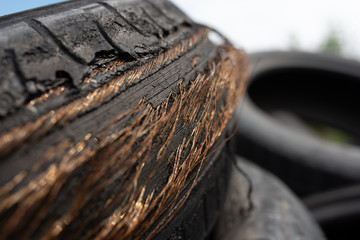 Very old, worn down to the wire, car rubber.