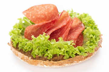 Sandwich with salami sausage on white background.