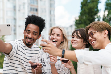 Happy group of friends with red wine