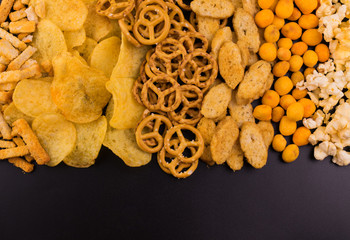 
Junk food. A lot of junk food on a black background.
Copy space.