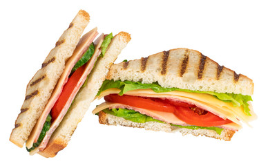 Sandwich with ham, cheese, tomato, lettuce and toasted bread isolated on a white background